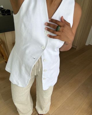 Woman in white linen vest.